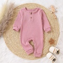 A multicolored knitted romper for children, showcasing a distinctive elegance and modern style 