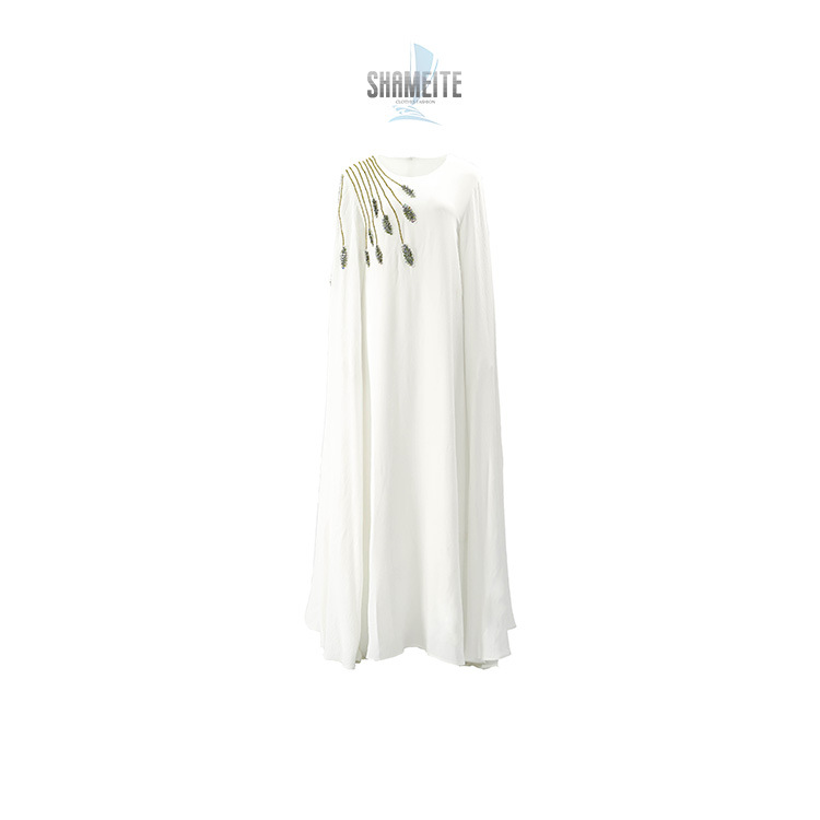 A long dress with flared sleeves and a traditional design that highlights the beauty of Eastern elegance