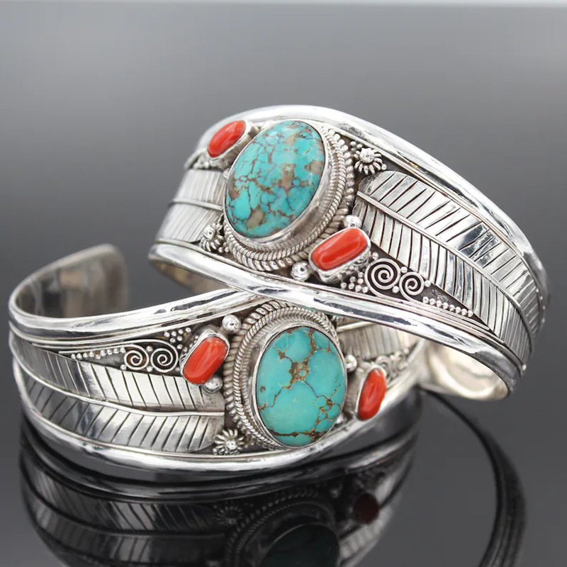 A stylish bracelet adorned with turquoise stone and traditional engravings, adding a unique and vintage touch