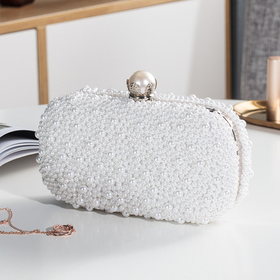 An elegant pearl-adorned clutch that adds a touch of luxury to your look for special occasions