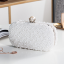 An elegant pearl-adorned clutch that adds a touch of luxury to your look for special occasions