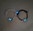 A luxurious jewelry set including a necklace and bracelet with a glowing blue butterfly design, illuminating in the dark for a captivating touch 