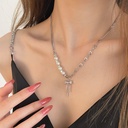 A unique and elegant necklace featuring a bow design with pearls, adding a touch of sophistication and charm to your look