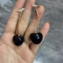 Attractive earrings featuring a wonderful combination of red and black cherries, adding a charming and elegant touch to your look