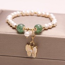 An elegant necklace featuring freshwater pearls and strawberry quartz, with an opal butterfly pendant, adding a touch of elegance and beauty to your look