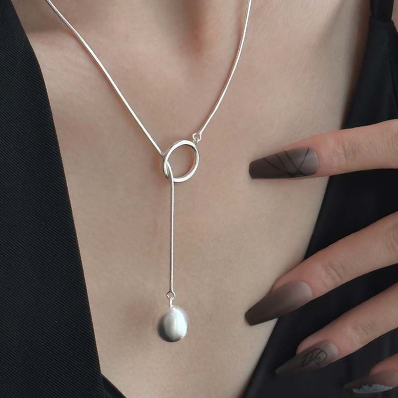 An elegant and stylish necklace featuring a round ball ring design, perfect for adding personality and a unique touch to your look