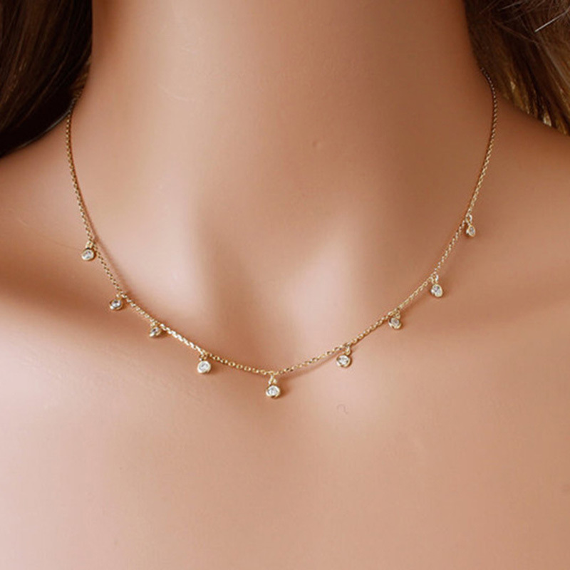 A simple and elegant necklace featuring a small diamond, perfect for adding a subtle touch of elegance to your look