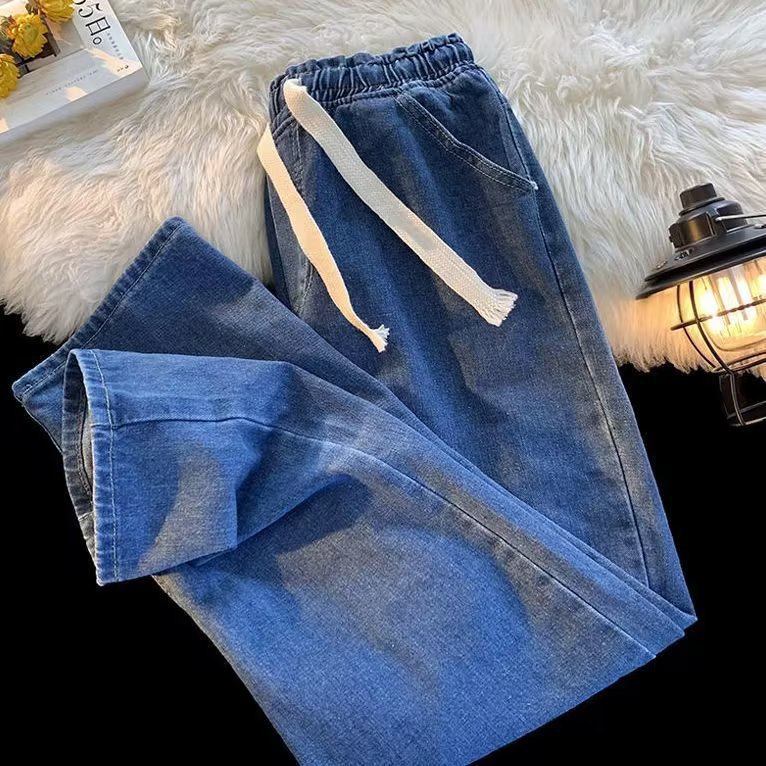 Modern and stylish denim pants that combine comfort and elegance, featuring an elastic waistband with an adjustable drawstring and a straight-leg cut for a sleek and practical everyday look