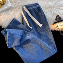 Modern and stylish denim pants that combine comfort and elegance, featuring an elastic waistband with an adjustable drawstring and a straight-leg cut for a sleek and practical everyday look