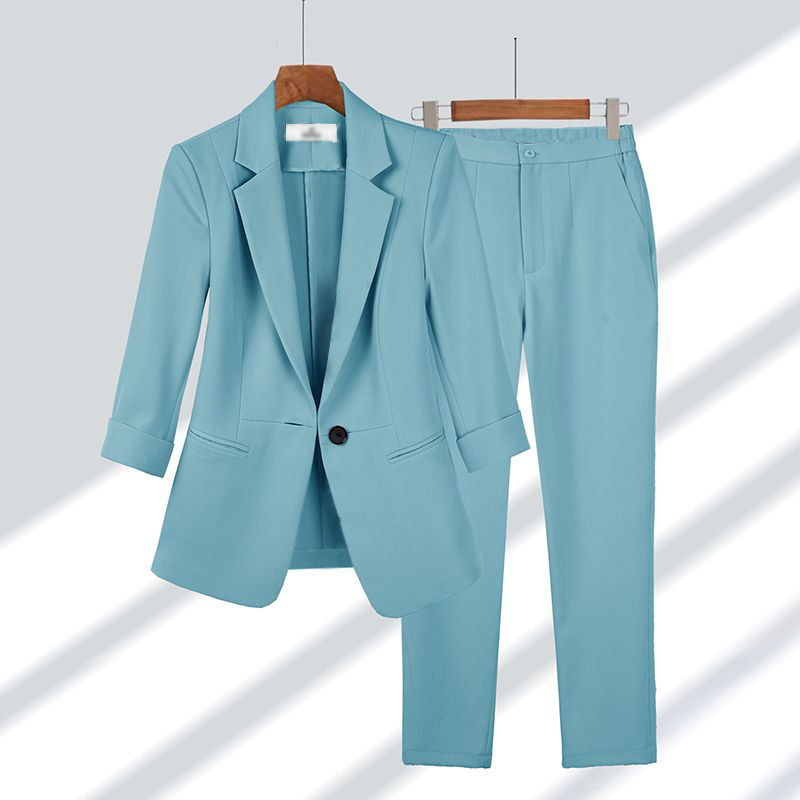 Practical and modern women's set consisting of a casual blazer with front buttons and straight zipper pants in a solid color