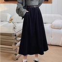 Long skirt with a high waist and wide hem, featuring an elegant design suitable for all seasons