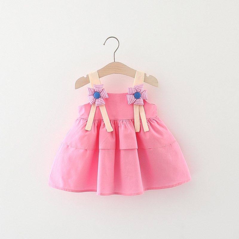 Elegant children's sling dress adorned with a floral print and a unique modern touch
