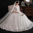 Elegant one-shoulder dress with slim lace sleeves and a dreamy feminine design