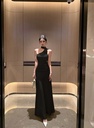 An elegant women’s dress inspired by French style, featuring a sloping shoulder design