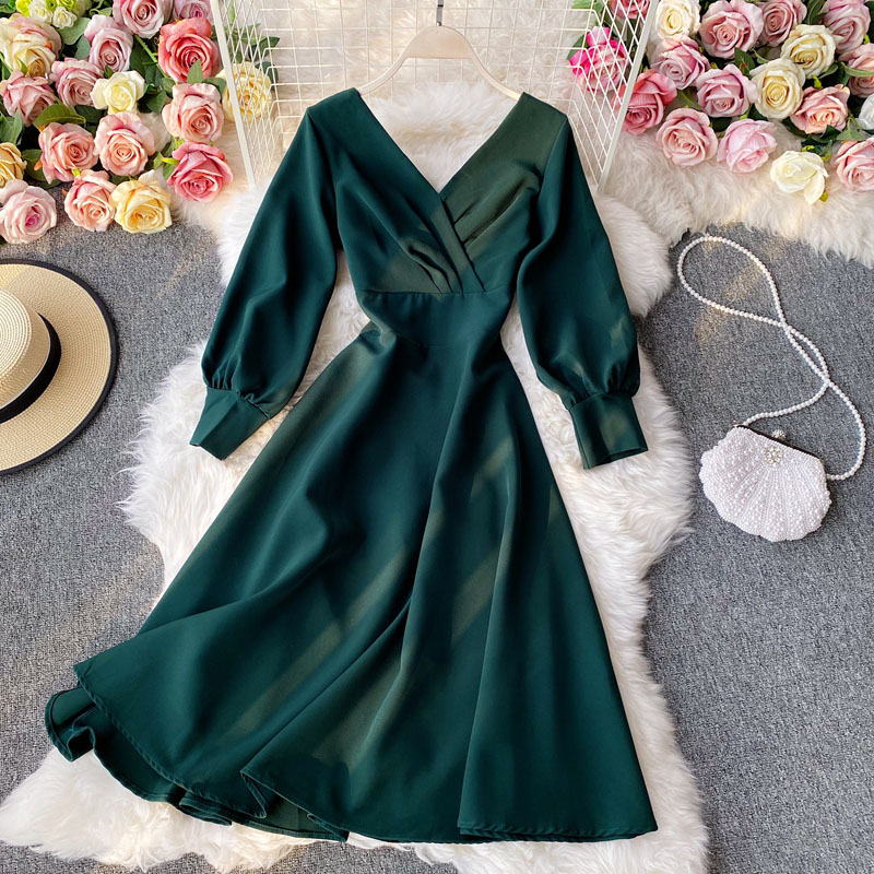Elegant French dress featuring long sleeves, a V-neck, and a flowing silhouette