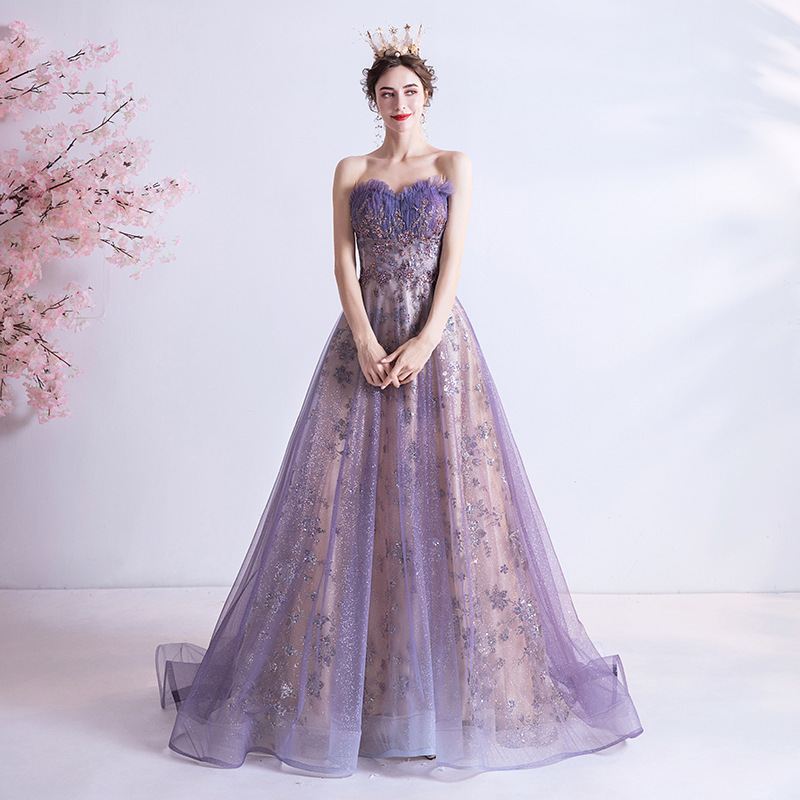 A strapless evening gown adorned with shimmering purple sequins, like a sky full of stars