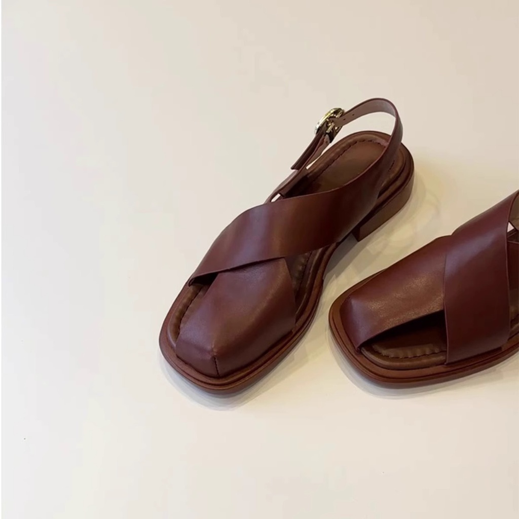Women’s European‑style sandals featuring hollow‑out details and an elegant buckle strap