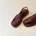 Women’s European‑style sandals featuring hollow‑out details and an elegant buckle strap