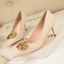 Women’s high-heeled shoes featuring a low-cut vamp and a sleek metal buckle