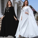 A long dress with flared sleeves and a traditional design that highlights the beauty of Eastern elegance