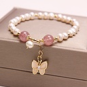 An elegant necklace featuring freshwater pearls and strawberry quartz, with an opal butterfly pendant, adding a touch of elegance and beauty to your look