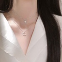 A stunning double-layer necklace featuring a celestial moon design, perfect for adding an elegant touch to your look