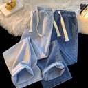 Modern and stylish denim pants that combine comfort and elegance, featuring an elastic waistband with an adjustable drawstring and a straight-leg cut for a sleek and practical everyday look