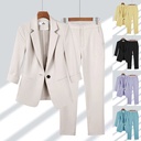 Practical and modern women's set consisting of a casual blazer with front buttons and straight zipper pants in a solid color