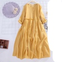 Long, loose-fitting linen dress in a solid color, featuring a flowing and elegant design that adds a touch of comfort and simplicity to your look
