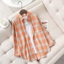 Loose-fit women's plaid shirt with long sleeves, featuring a retro chic design perfect for casual looks