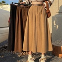 Long skirt with a high waist and wide hem, featuring an elegant design suitable for all seasons