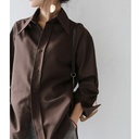 Elegant loose-fitting women's shirt with long sleeves and a solid color, suitable for all occasions