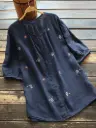 Embroidered women's blouse with a crew neck, elegant button design, and short sleeves