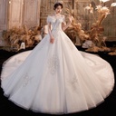 Elegant wedding dress with a luxurious design and long train, offering a magical and feminine look like a fairytale princess