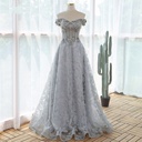 Evening dress made of lace and adorned with elegant floral details