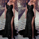 Elegant evening dress with one-shoulder design and shimmering fabric, featuring a side slit for a captivating look