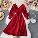 Elegant French dress featuring long sleeves, a V-neck, and a flowing silhouette