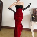 A strapless evening gown with a fitted silhouette and a fishtail hem
