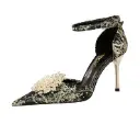 Low‑strap pointed stiletto embellished with rhinestones, pearls, and floral accents