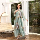 A luxurious and elegant caftan dress, embellished with beads and embroidery, inspired by authentic Arabic heritage